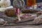 Several variety of traditional Corsican charcuterie with an olive branch and black olives on wooden background.