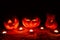 Several very scary Halloween pumpkins, with a menacing gaze and