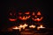 Several very scary Halloween pumpkins, with a menacing gaze and