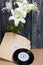 Several vinyl records and blossoming lilies against a background of black and white pine boards