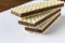 Several wafers with chocolate on a light background. Selective focus