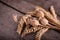 Several wheat ears and dry poppies on a old wooden table