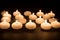 Several white candles at a black background