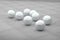 Several white futuristic balls on ceramic floor