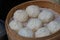 Several white steamed buns in steamer