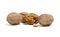 Several whole walnuts and one open on a white background
