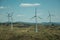 Several wind turbines over hilly landscape