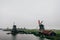 Several windmills  in a dark and cloudy day in Zaanse Schans  The Netherlands with fog