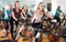 Several women of different age training on exercise bikes