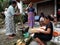 Several women handle food in the yard of a house by Lake Toba, Pulau Samosir. Indonesia