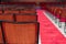 several wooden and red velvet chairs from the concert hall at Coliseu dos recreios in Lisbon