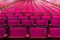 several wooden and red velvet chairs from the concert hall at Coliseu dos recreios in Lisbon