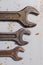 Several wrenches on the background of metal plates. vertical vie