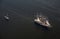 Several yachts and sailboats go to sea under sail. View from above.