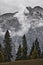 Severe stone rocky mountain peak, and gloomy fir