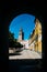 Seville Cathedral`s Moorish Giralda tower as framed from a doorway at courtyard in Real Alcazar, Sevilla, Andalusia