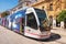 Seville, Spain - May 20, 2019:  A modern comfortable tram on the city street. Seville. Andalusia Spain.