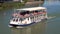 Seville, Spain - May 20, 2019: Tourist enjoying a river cruise at Guadalquivir River, Seville, Spain.