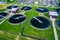 Sewage Farm Aerial View. Clarifying tanks and green grass. Top view of sewage treatment plant. Geometric background texture