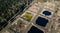 Sewage farm. Static aerial photo looking down onto the clarifying tanks and green grass