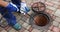 Sewer cleaning service - worker clean a clogged drainage with hydro jetting