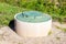 Sewer manhole of rural septic tank with green plastic cover, sewage system