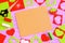 Sewing handicraft background. Felt strawberry toy, scissors, red and green felt sheets and scraps, thread, needle, paper pattern