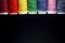 Sewing Quilting Thread, Rainbow colors. on black background with place for your own text