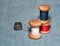 Sewing spools with colorful threads and needles, metal thimble l