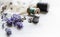 Sewing tools with fresh lavander flowers on linen background. Vintage wooden spool, braid, thimble, buttons.