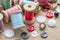 Sewing tools many different colorful thread, needle, many different buttons on wooden background.