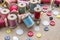 Sewing tools many different colorful thread, needle, many different buttons on wooden background.