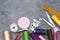 Sewing tools : scissors, colorful bobbins with thread and presser foot on gray wooden table, top view - Image.