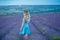 Sex appeal blond woman in airy blue dress enjoy life time vacation on fresh lavender field by walking or spinning around. Sylph