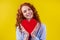 Sex education concept.redhaired ginger curly woman holding heart paper valentites card in studio yellow background