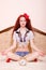 Sexi young redhead woman meditating in lotus pose