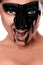 Sexual female with black paint on face screaming