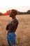 Sexual man posing shirtless in grain field