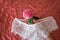 Sexual woman`s white underwear. unmade bed.Openwork cotton lingerie on a crumpled sheet. red silk blanket. Red rose - concept