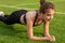 Sexy athletic girl shakes the press on the grass of the stadium