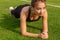 Sexy athletic girl shakes the press on the grass of the stadium