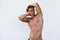 Sexy athletic man with naked torso on white background. Fashion portrait of sporty healthy guy