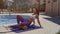 Sexy athletic woman doing fitness massage outdoors