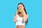 Sexy athletic woman enjoying eating hamburger on blue background