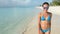 Sexy Beach bikini Asian woman walking on beach wearing sunglasses