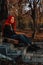 Sexy beautiful redhead girl with magnificent long hair. Ukulele playing, sitting on the steps in the park. Perfect woman portrait