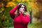 Sexy beautiful woman in autumn, cute plus size model in red sweater outdoors