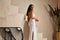 Sexy beautiful woman brunette tanned skin makeup cosmetic fashion clothes summer collection white cotton dress accessory bag style