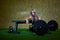 Sexy blonde athletic woman in a black tight leggings lifting a weight cross-fit in the gym