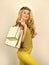 Sexy blonde carry shopping bags. elegant woman shopaholic. girl shopper hold paperbag package. buy presents online. gift